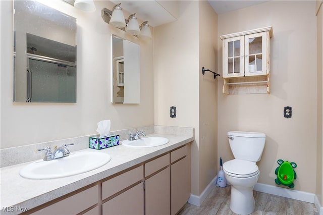 bathroom featuring vanity, toilet, and walk in shower