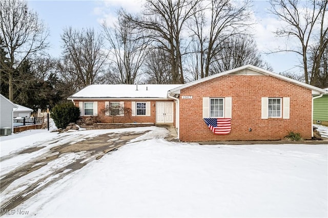 view of snow covered back of property