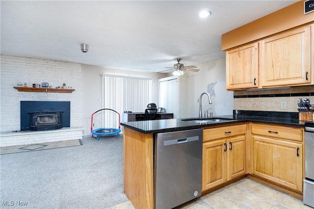 kitchen with sink, dishwasher, ceiling fan, backsplash, and kitchen peninsula