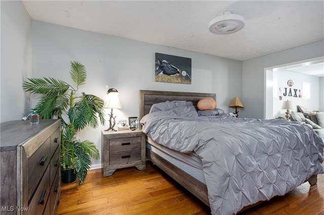 bedroom featuring dark hardwood / wood-style floors and a textured ceiling