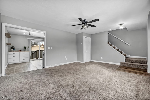 unfurnished living room with light carpet and ceiling fan