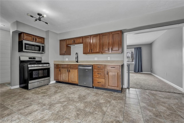 kitchen featuring sink, light tile patterned flooring, and appliances with stainless steel finishes