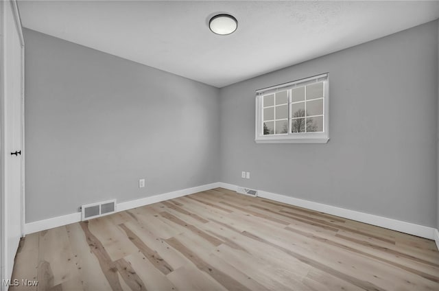 unfurnished room featuring light hardwood / wood-style flooring