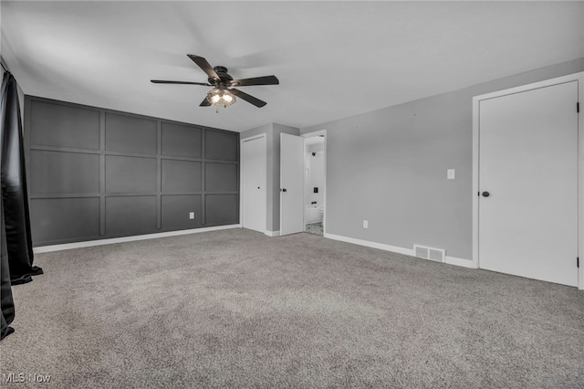 empty room with ceiling fan and carpet