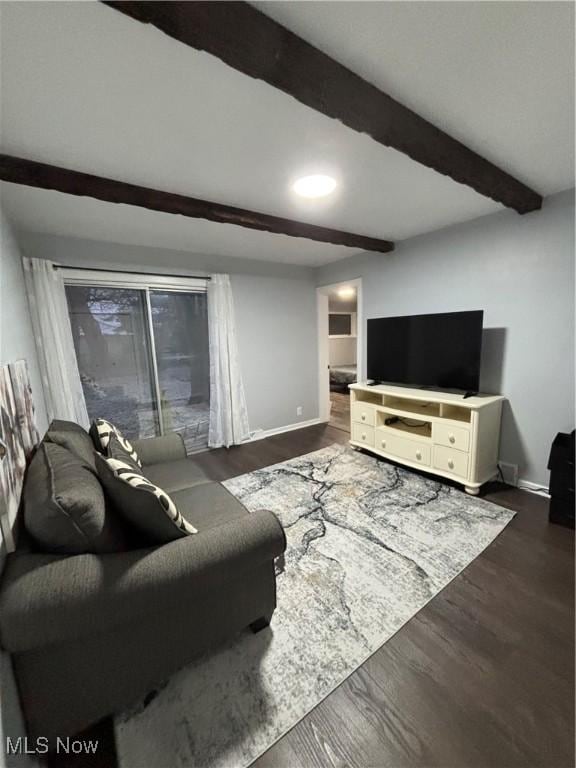 living room with dark wood-type flooring and beam ceiling