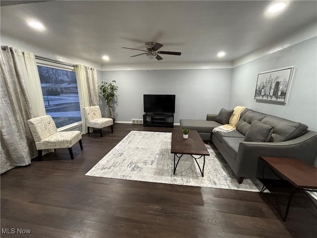 living room featuring dark hardwood / wood-style flooring and ceiling fan