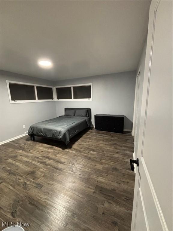 bedroom with dark hardwood / wood-style flooring