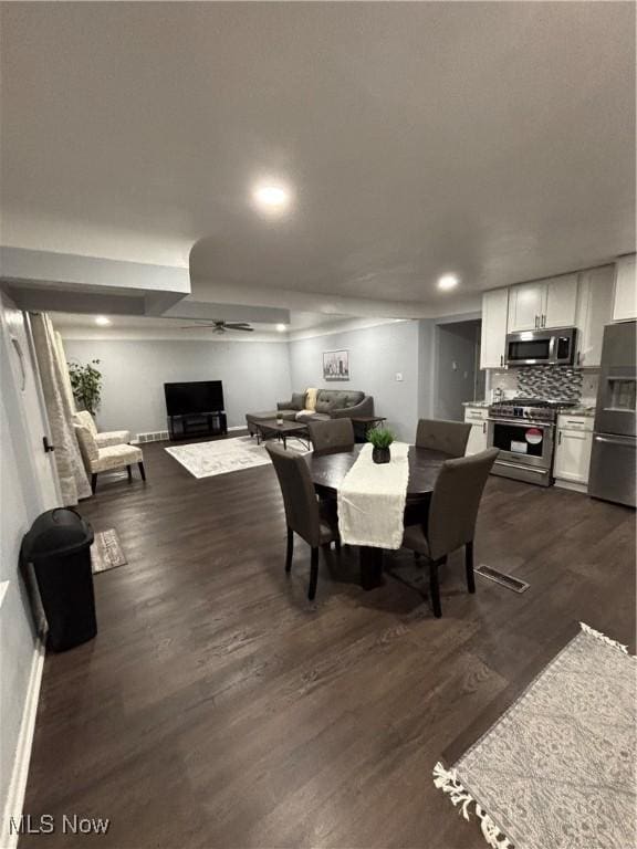 dining space with dark wood-type flooring