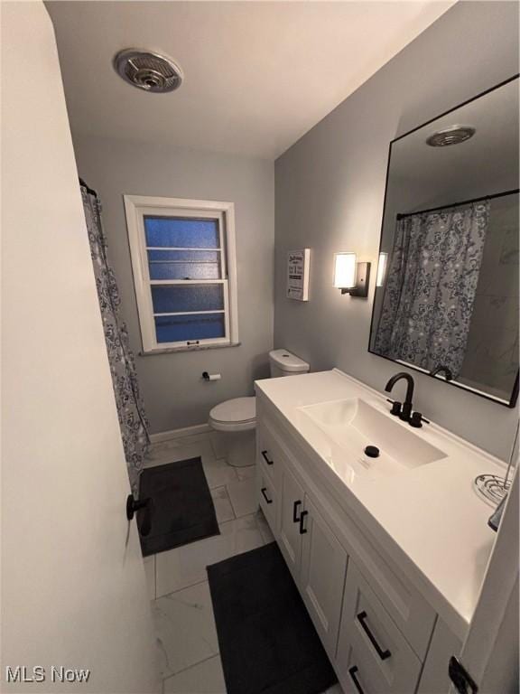 bathroom with vanity and toilet