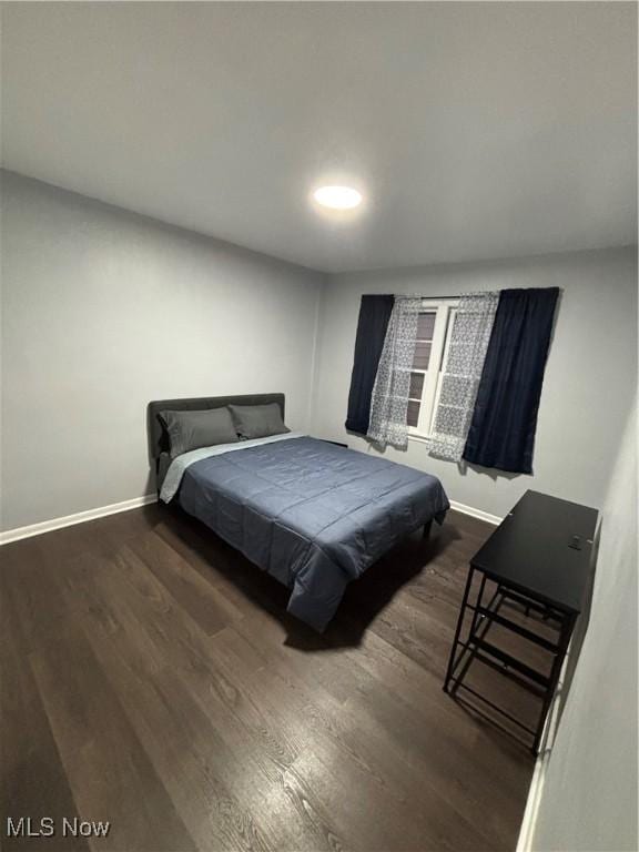 bedroom featuring dark hardwood / wood-style flooring