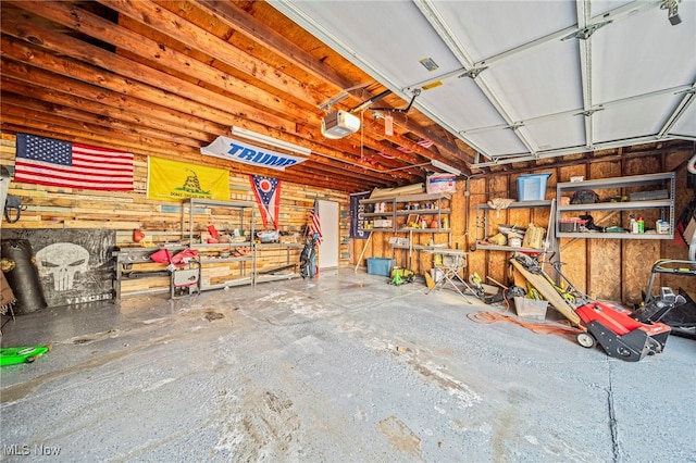 garage with a garage door opener and a workshop area