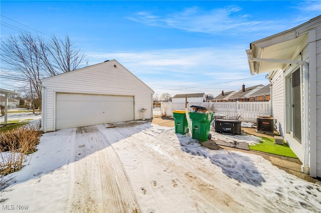 snow covered garage featuring central AC