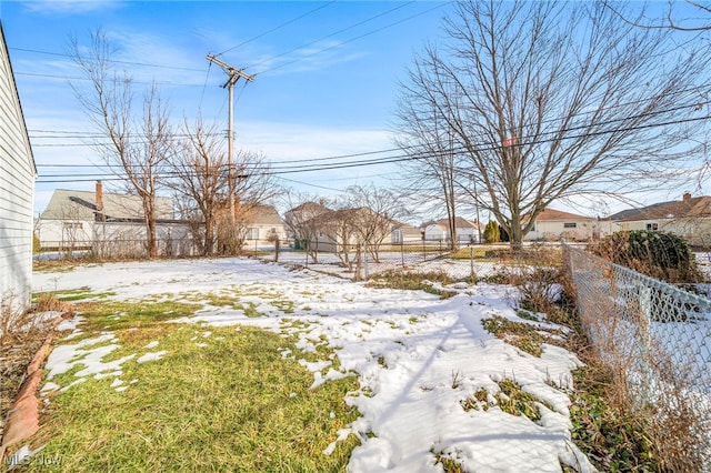 view of yard layered in snow