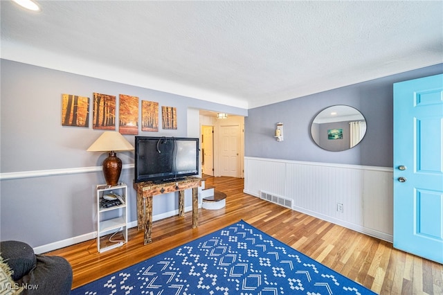 living room featuring hardwood / wood-style floors and a textured ceiling