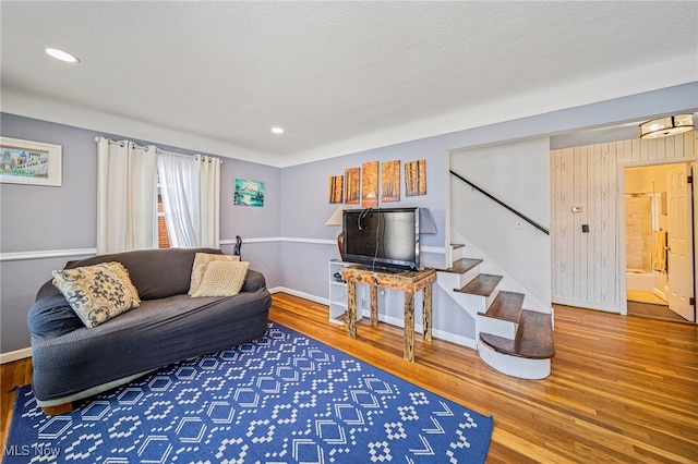 living room with hardwood / wood-style floors and a textured ceiling