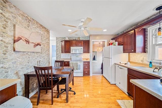 kitchen with pendant lighting, white appliances, ceiling fan, light hardwood / wood-style floors, and decorative backsplash