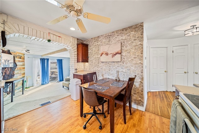 dining space featuring ceiling fan and light hardwood / wood-style floors