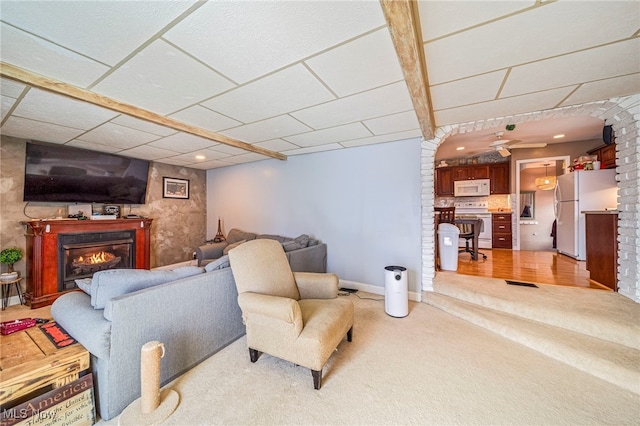 carpeted living room featuring a paneled ceiling