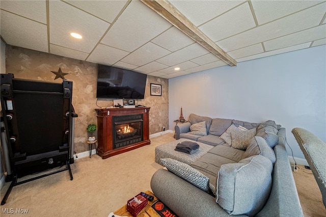 living room featuring carpet floors and a paneled ceiling