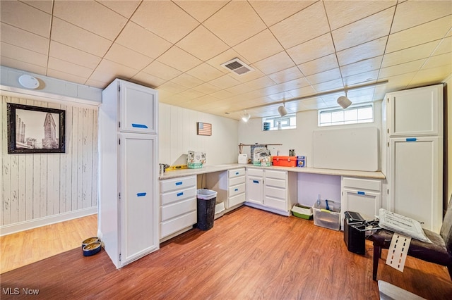 kitchen with white cabinetry and light hardwood / wood-style floors