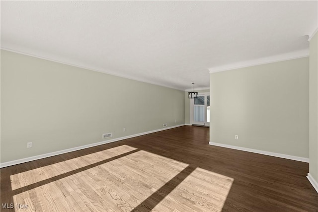 unfurnished room with dark wood-type flooring and ornamental molding