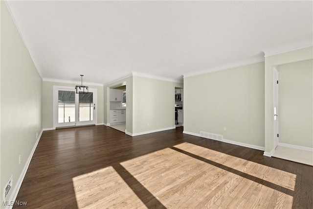 unfurnished living room featuring crown molding and dark hardwood / wood-style floors