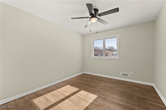 spare room with hardwood / wood-style floors and ceiling fan