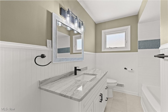 bathroom with tile patterned flooring, vanity, and toilet