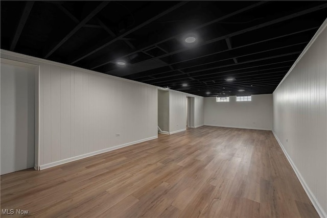 basement with hardwood / wood-style floors