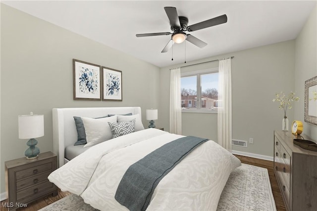 bedroom with dark hardwood / wood-style floors and ceiling fan