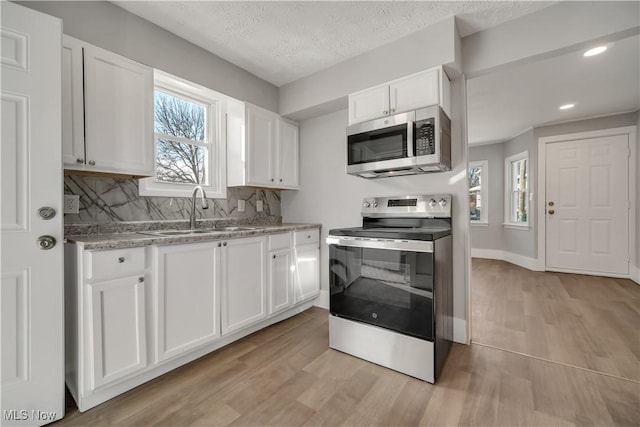 kitchen featuring white cabinetry, appliances with stainless steel finishes, and sink