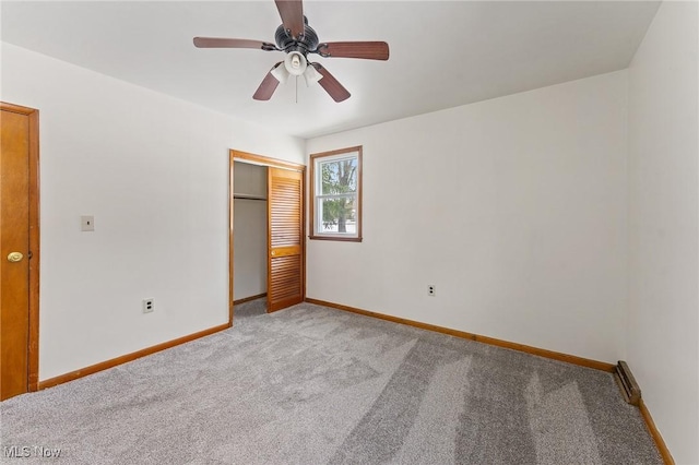 unfurnished bedroom with light carpet, a closet, and ceiling fan