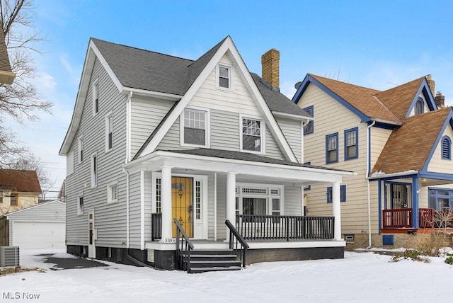 view of front facade with an outbuilding, a porch, a garage, and central air condition unit