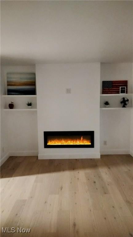 unfurnished living room featuring light hardwood / wood-style flooring