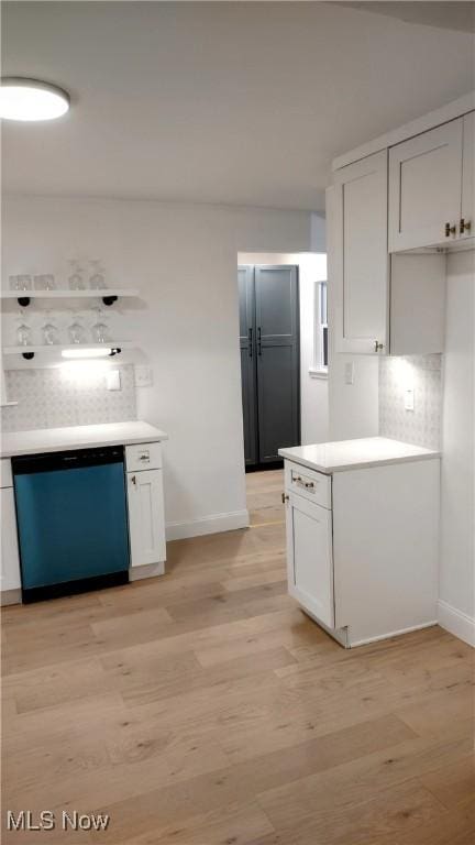 kitchen featuring tasteful backsplash, light hardwood / wood-style flooring, stainless steel dishwasher, and white cabinets