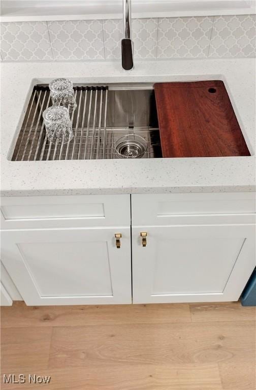 details with white cabinets and light stone counters