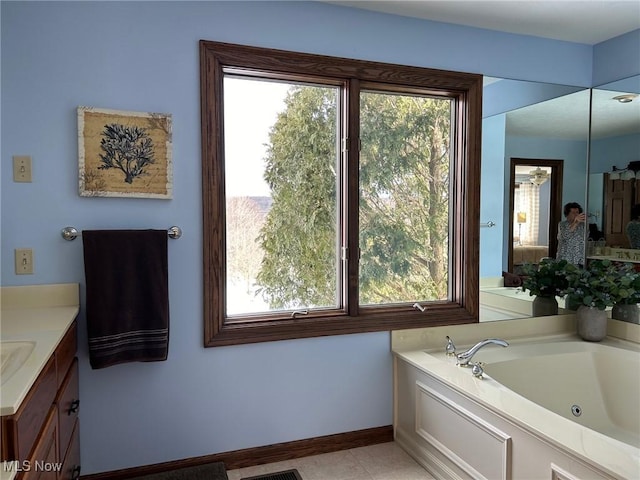 full bathroom with tile patterned flooring, baseboards, vanity, and a tub with jets