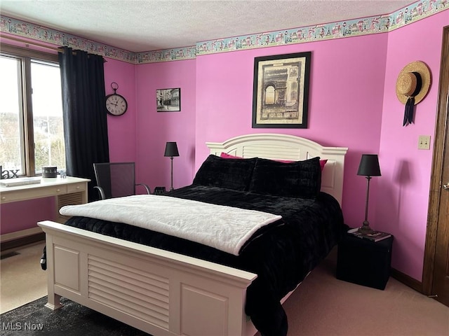 bedroom with dark carpet, a textured ceiling, and baseboards