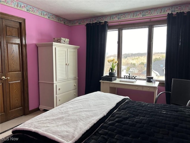 bedroom featuring carpet and a textured ceiling