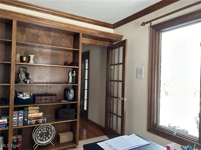 interior space featuring crown molding, a textured ceiling, and wood finished floors