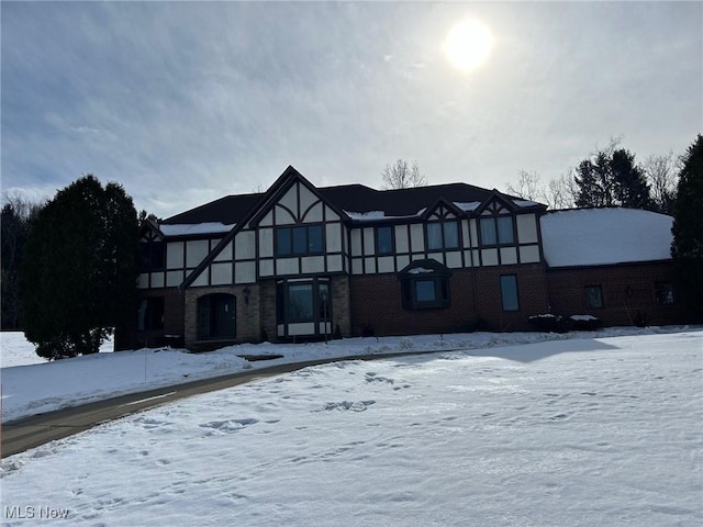 view of snow covered back of property