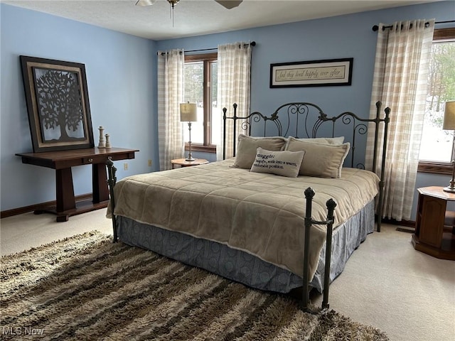 bedroom featuring baseboards, ceiling fan, and light colored carpet