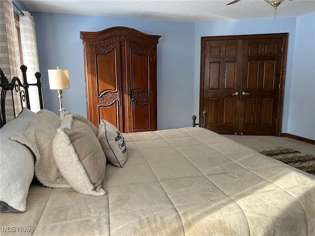 bedroom featuring ceiling fan and baseboards