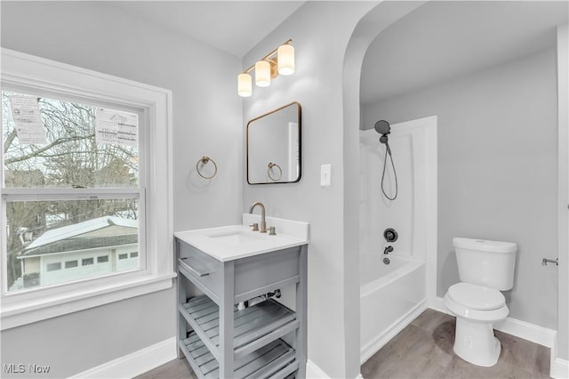 3295 Yorkshire Rd, Cleveland Heights, OH 44118 - bathroom with baseboards, toilet, vanity, shower / bathtub combination, and wood finished floors