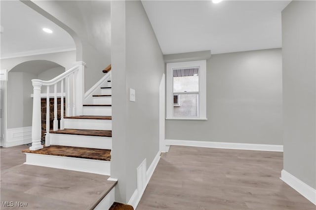 stairs featuring hardwood / wood-style floors
