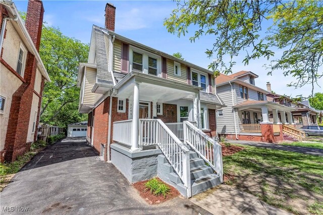 3295 Yorkshire Rd, Cleveland Heights, OH 44118 - view of front of property with an outdoor structure, brick siding, a chimney, a porch, and a garage