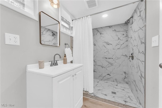 3295 Yorkshire Rd, Cleveland Heights, OH 44118 - bathroom featuring a marble finish shower, vanity, recessed lighting, and wood finished floors