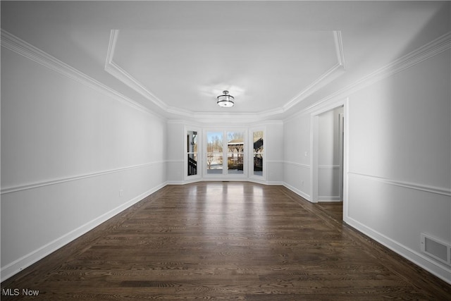 empty room with ornamental molding and dark hardwood / wood-style flooring