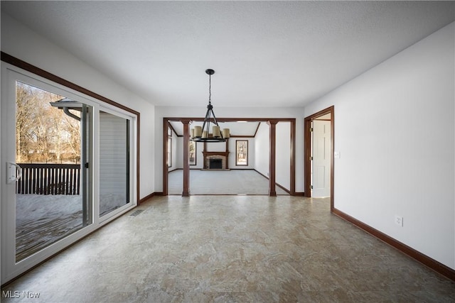 unfurnished dining area featuring a chandelier