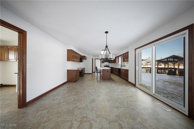 kitchen with hanging light fixtures, sink, and a center island